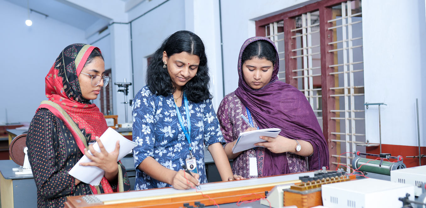 Women students in lab coats performing chemistry experiments with glassware in a college laboratory